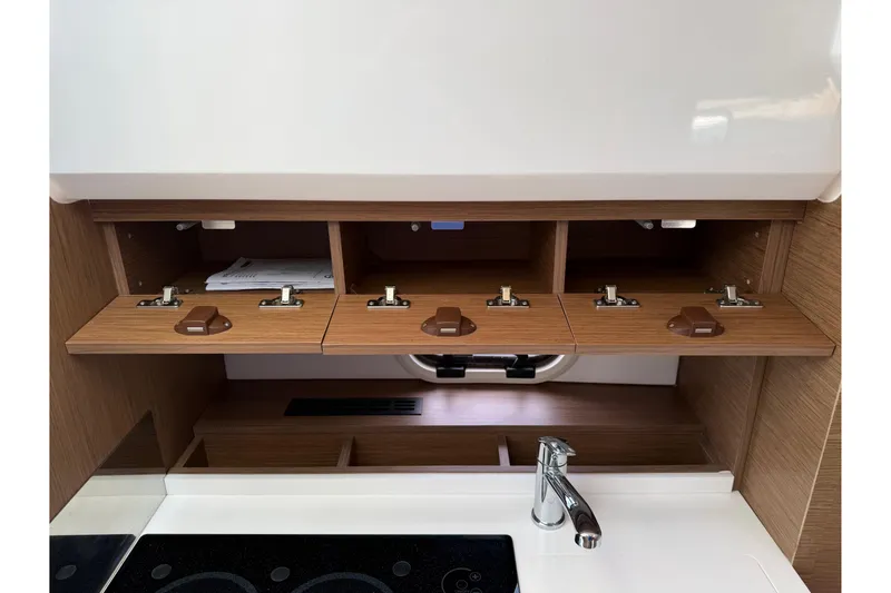 Slide: The Image of Interior of 2019 Jeanneau Leader 10.5 boat with wooden cabinets and modern fixtures. - 81