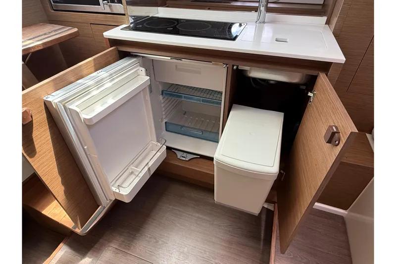 Slide: The Image of 2019 Jeanneau Leader 10.5 yacht kitchen with open fridge and storage cabinets. - 82
