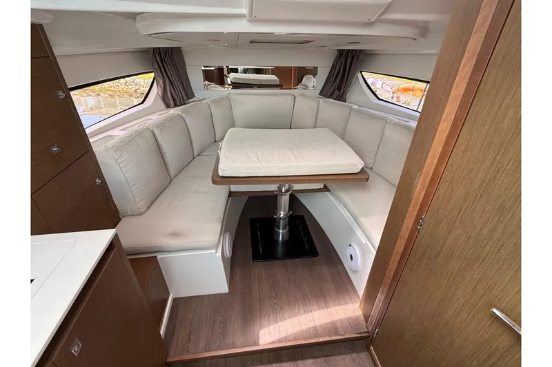 Slide: The Image of Interior of 2019 Jeanneau Leader 10.5 boat with cozy seating and table. - 83