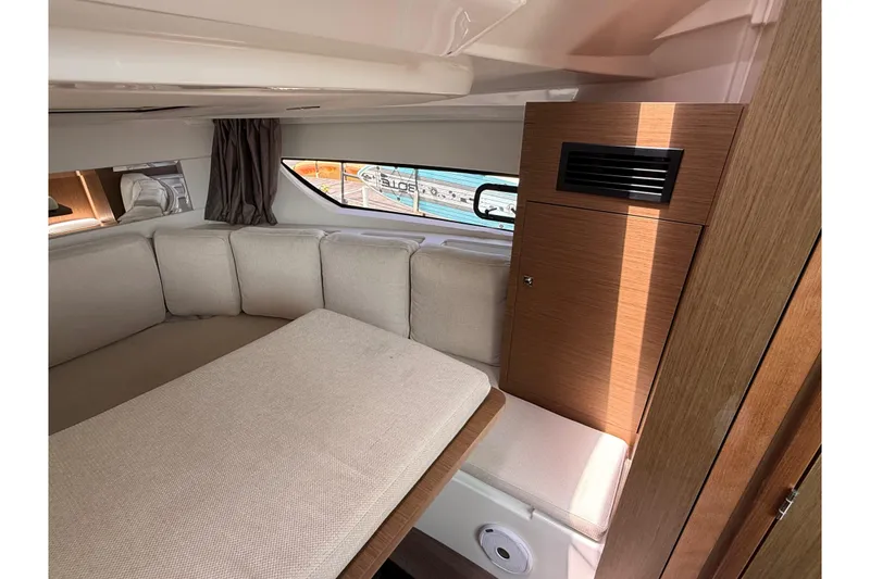 Slide: The Image of Interior of 2019 Jeanneau Leader 10.5 yacht with cozy seating and wooden cabinetry. - 86
