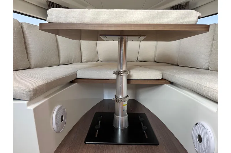 Slide: The Image of Interior of 2019 Jeanneau Leader 10.5 boat with cushioned seating and table. - 89