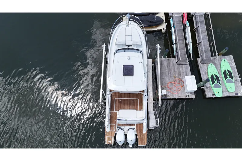 Slide: The Image of Overhead view of 2019 Jeanneau Leader 10.5 docked with paddleboards nearby. - 9