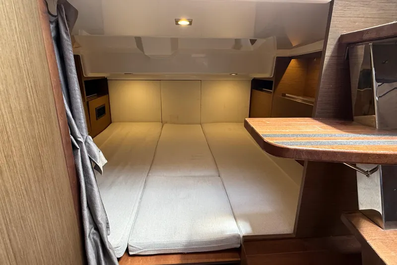 Slide: The Image of Interior cabin of 2019 Jeanneau Leader 10.5 with cozy bedding and wooden accents. - 90