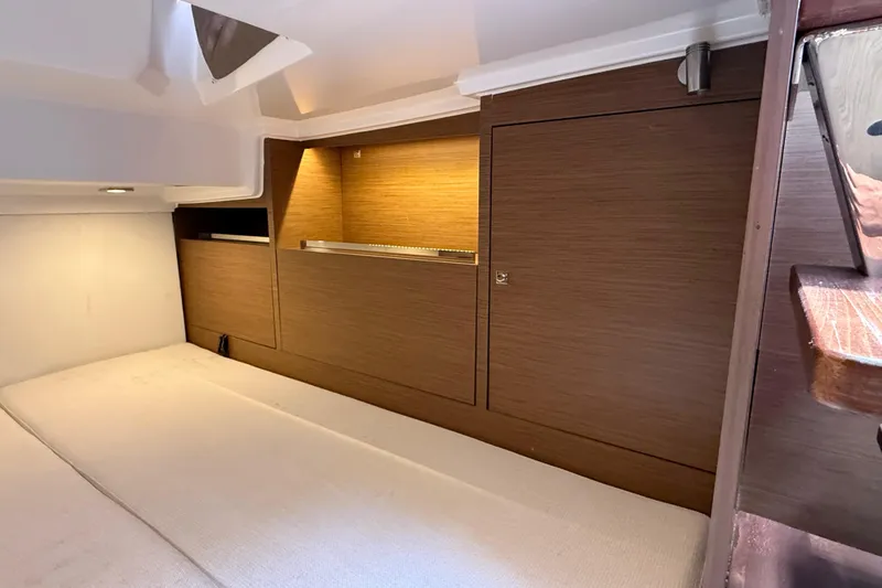 Slide: The Image of Interior cabin of 2019 Jeanneau Leader 10.5 with wooden cabinetry and cozy bedding. - 91