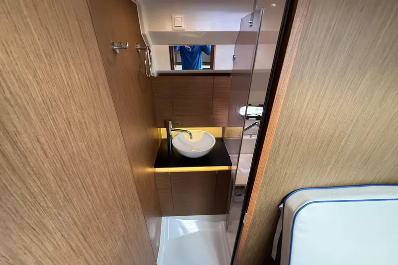 Slide: The Image of 2019 Jeanneau Leader 10.5 yacht interior with modern bathroom and wooden cabinetry. - 93