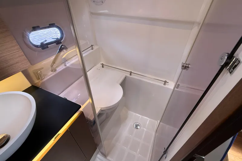 Slide: The Image of Bathroom interior of 2019 Jeanneau Leader 10.5 boat, featuring modern fixtures and compact design. - 95