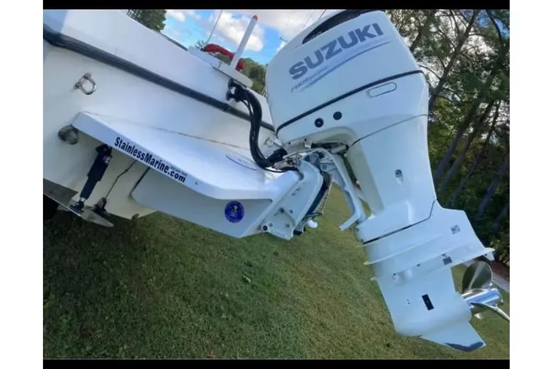 Slide: The Image of 2011 C-Hawk 235 Center Console with Suzuki outboard motor on grassy area. - 2