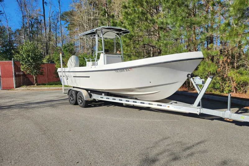 Slide: The Image of 2011 C-Hawk 235 Center Console boat on trailer, parked outdoors. - 3