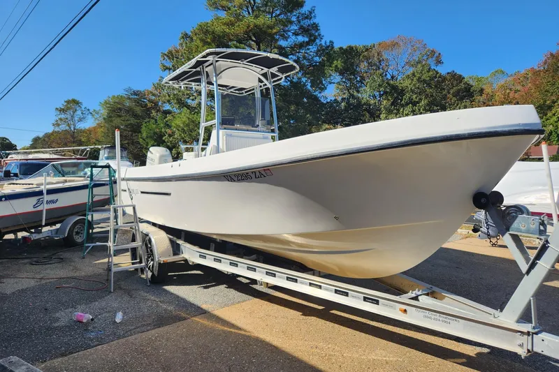 Slide: The Image of 2011 C-Hawk 235 Center Console boat on trailer, parked outdoors. - 4