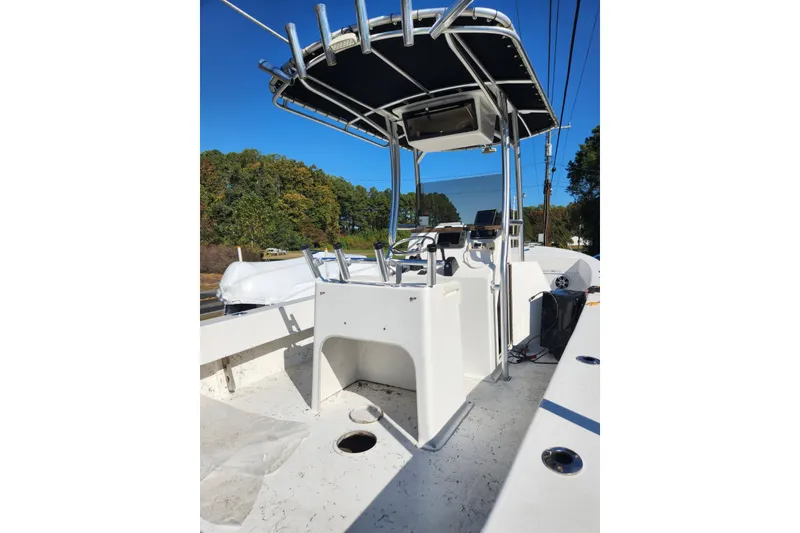 Slide: The Image of 2011 C-Hawk 235 Center Console boat with T-top and console, outdoors. - 6
