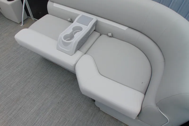 Slide: The Image of 2024 Godfrey Sweetwater 2086 C boat seating with cup holders, featuring light gray upholstery. - 11