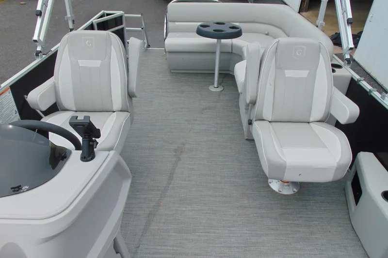Slide: The Image of 2024 Godfrey Sweetwater 2086 C pontoon boat interior with plush seating and table. - 13