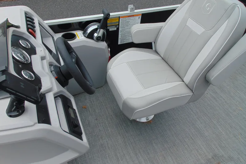 Slide: The Image of 2024 Godfrey Sweetwater 2086 C boat interior with steering wheel and captain's chair. - 15