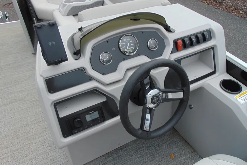 Slide: The Image of 2024 Godfrey Sweetwater 2086 C dashboard with steering wheel and control panel. - 16