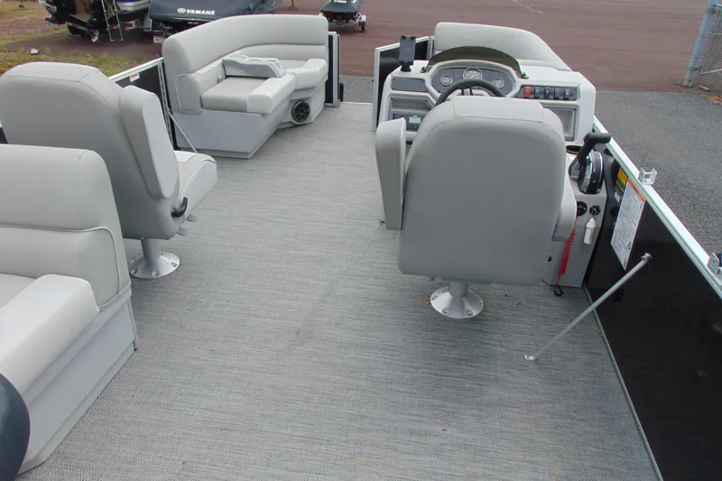 Slide: The Image of 2024 Godfrey Sweetwater 2086 C pontoon boat interior with gray seating and steering console. - 20
