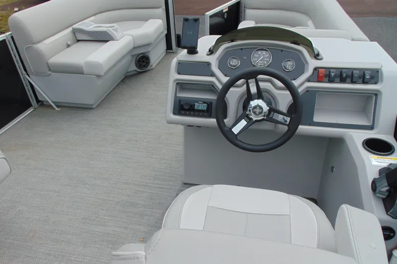 Slide: The Image of 2024 Godfrey Sweetwater 2086 C boat interior with steering wheel and seating area. - 21
