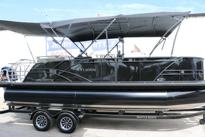The Image of 2025 Sylvan MIRAGE X3 DLZ BAR pontoon boat with sleek black design and canopy. - 0