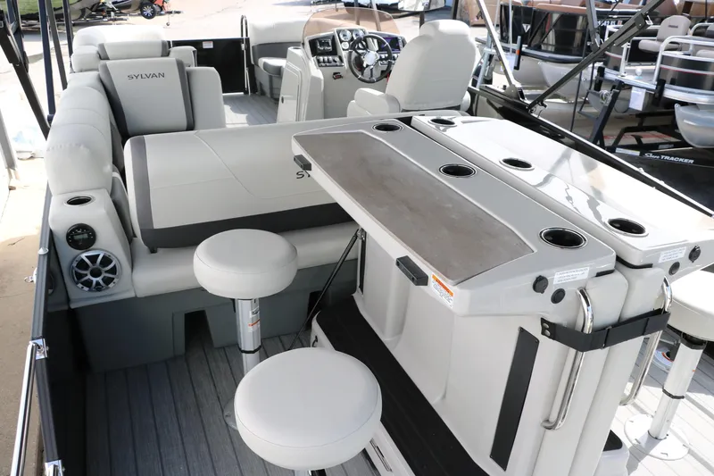 Slide: The Image of 2025 Sylvan MIRAGE X3 DLZ BAR interior with seating, bar area, and modern controls. - 15