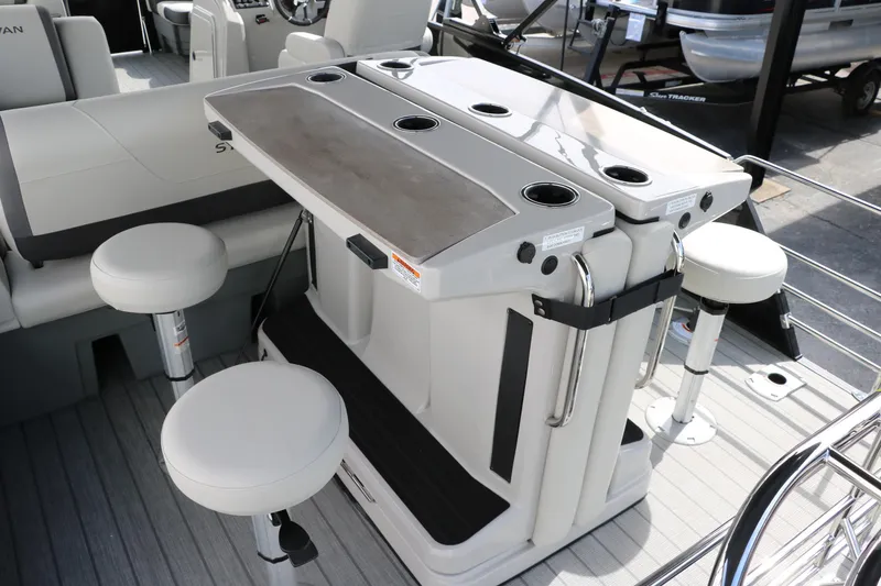 Slide: The Image of 2025 Sylvan MIRAGE X3 DLZ BAR boat interior with bar stools and sleek design. - 16