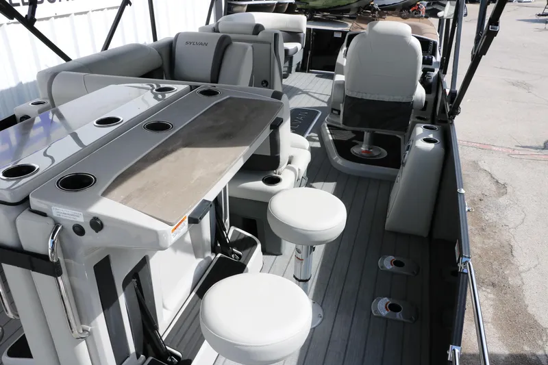 Slide: The Image of 2025 Sylvan MIRAGE X3 DLZ BAR interior with seating and bar setup. - 18