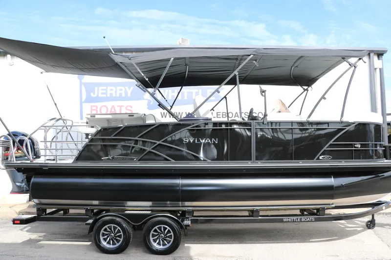 Slide: The Image of 2025 Sylvan MIRAGE X3 DLZ BAR pontoon boat with canopy on trailer. - 2