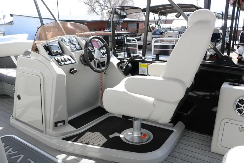 Slide: The Image of Captain's helm of 2025 Sylvan MIRAGE X3 DLZ BAR pontoon boat, featuring modern controls. - 21