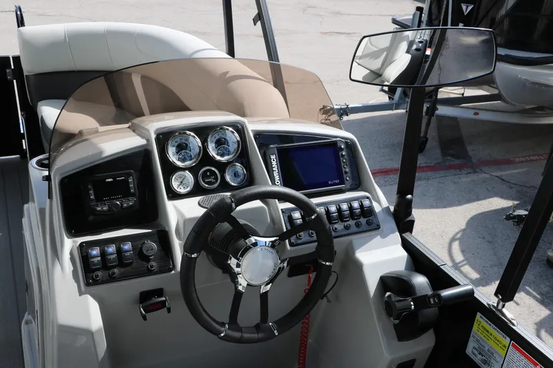 Slide: The Image of 2025 Sylvan MIRAGE X3 DLZ BAR boat dashboard with steering wheel and control panel. - 25