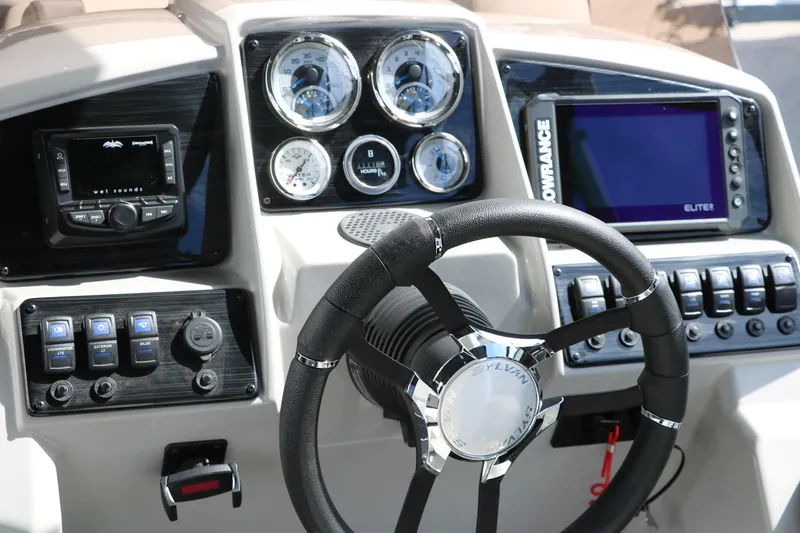 Slide: The Image of 2025 Sylvan MIRAGE X3 DLZ BAR boat dashboard with steering wheel and control panel. - 26