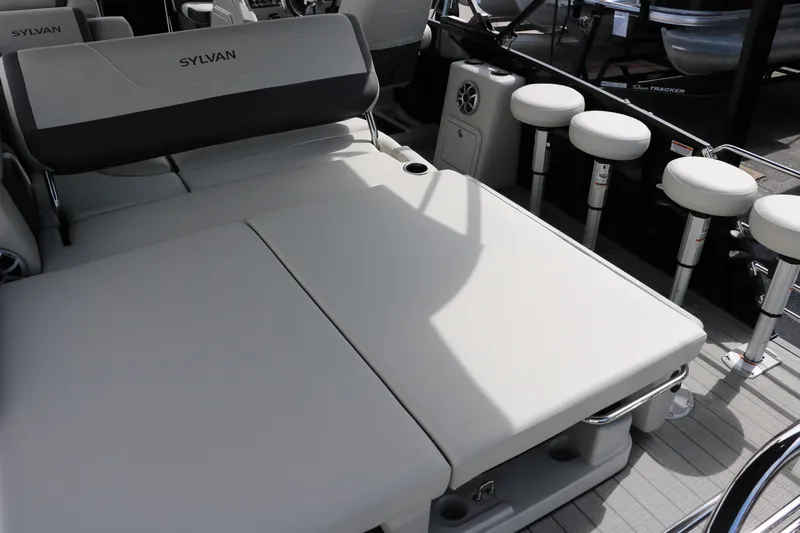 Slide: The Image of 2025 Sylvan MIRAGE X3 DLZ BAR boat interior with seating and bar stools. - 30