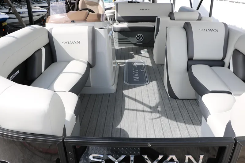 Slide: The Image of 2025 Sylvan MIRAGE X3 DLZ BAR pontoon boat interior with luxurious seating and modern design. - 9