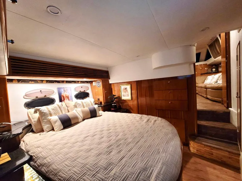 Slide: The Image of Luxurious bedroom interior of 2001 Carver 396 Motor Yacht with elegant bedding and wood accents. - 20