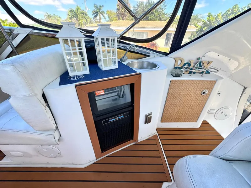 Slide: The Image of 2001 Carver 396 Motor Yacht interior with mini fridge, sink, and decorative lanterns. - 5