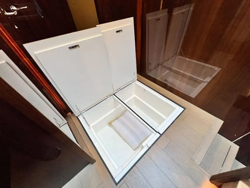 Slide: The Image of Open storage compartment on Fairline Squadron 68 yacht, 2020 model, with wooden flooring. - 22