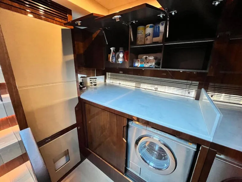 Slide: The Image of Laundry area in 2020 Fairline Squadron 68 yacht with washer and storage cabinets. - 32