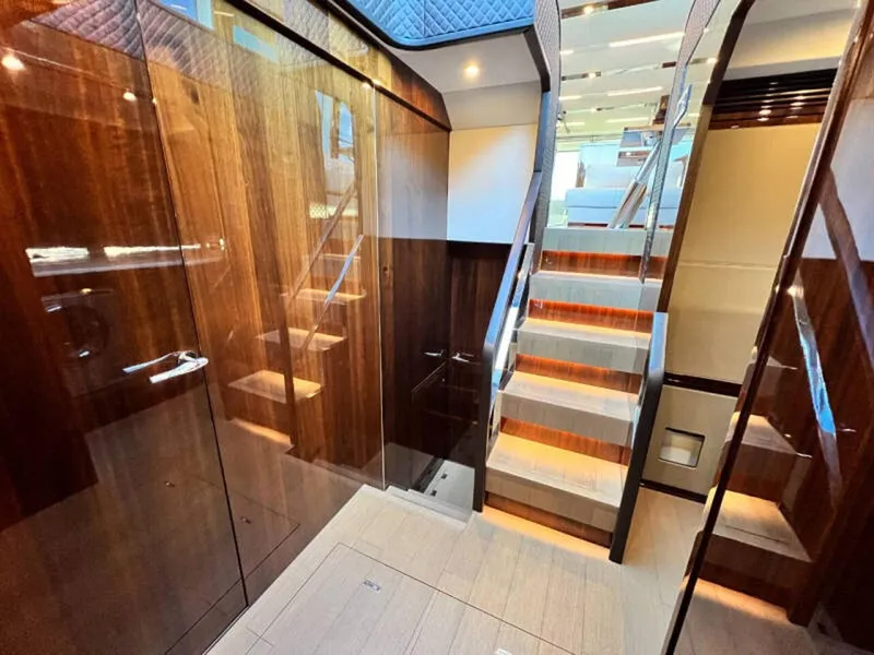 Slide: The Image of Luxurious interior of 2020 Fairline Squadron 68 yacht with polished wood and modern staircase. - 35