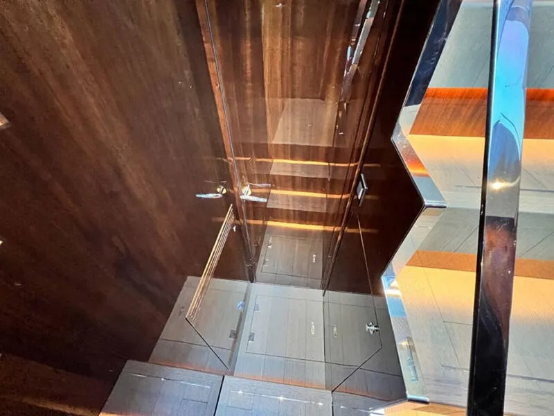 Slide: The Image of Luxurious interior of 2020 Fairline Squadron 68 yacht, featuring sleek wood and glass elements. - 39