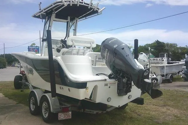 Slide: The Image of 2014 Sea Fox 226 Commander boat on trailer with outboard motor, parked outdoors. - 10