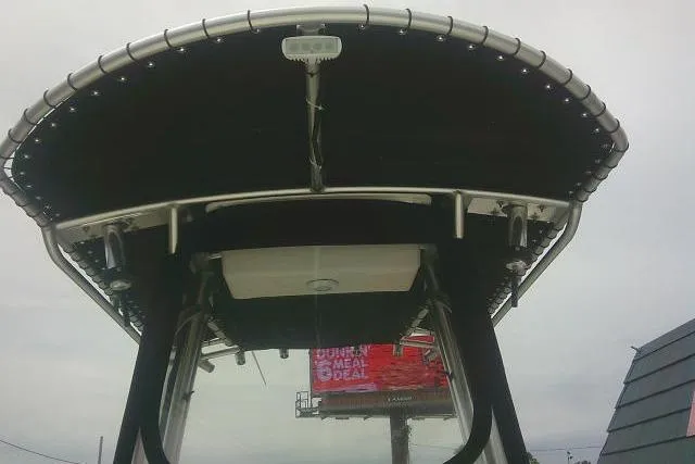 Slide: The Image of 2014 Sea Fox 226 Commander boat canopy with billboard in background. - 19