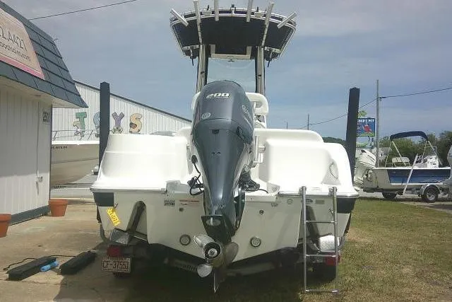 Slide: The Image of 2014 Sea Fox 226 Commander boat with Yamaha 200 engine, parked outdoors. - 2