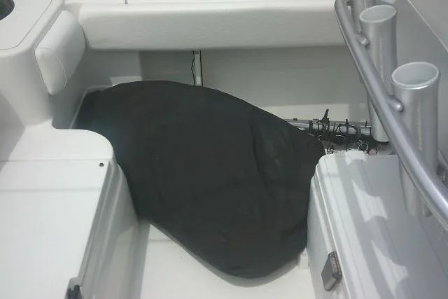 Slide: The Image of 2014 Sea Fox 226 Commander boat interior with covered equipment and rod holders. - 29