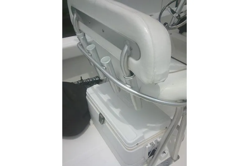 Slide: The Image of 2014 Sea Fox 226 Commander boat seat with rod holders and cooler storage. - 38