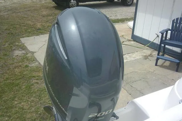 Slide: The Image of Outboard motor on a 2014 Sea Fox 226 Commander boat, parked outdoors. - 42