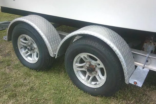 Slide: The Image of Trailer wheels of a 2014 Sea Fox 226 Commander boat on grass. - 7