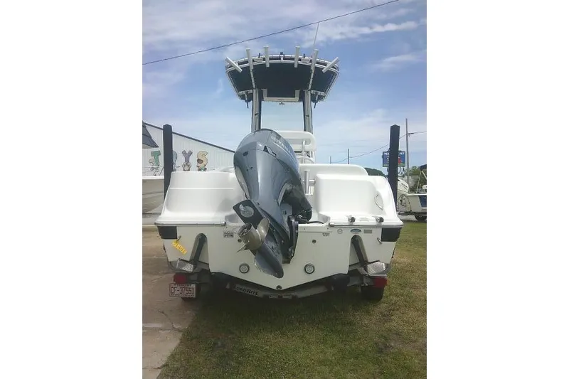 Slide: The Image of 2014 Sea Fox 226 Commander boat with outboard motor, parked on grass. - 9