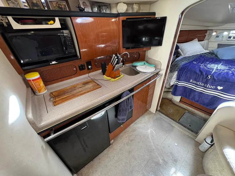 Slide: The Image of Interior of 2002 Sea Ray 360 Sundancer yacht with kitchenette and cozy bedroom. - 28