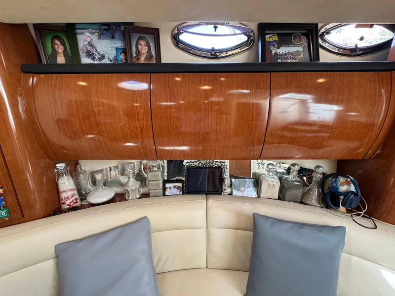 Slide: The Image of Interior of 2002 Sea Ray 360 Sundancer with wooden cabinets and decorative items. - 24