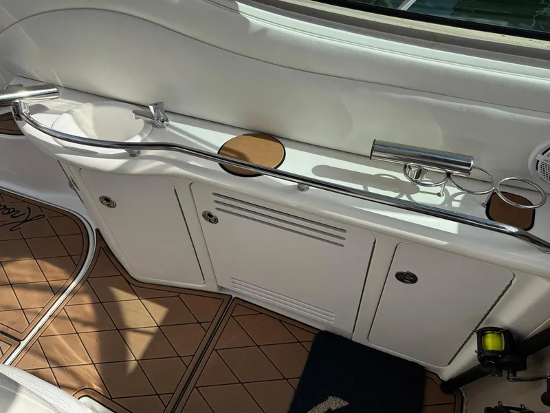 Slide: The Image of 2002 Sea Ray 360 Sundancer cockpit with white cabinetry and stainless steel railings. - 19