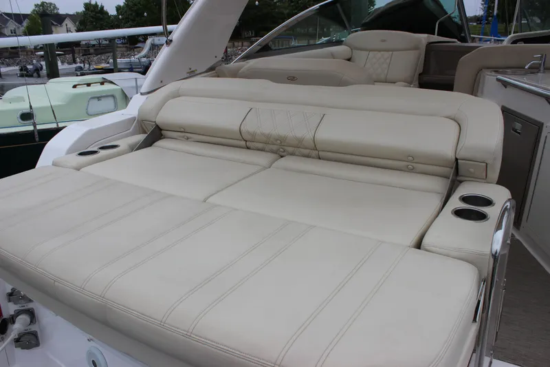 Slide: The Image of 2018 Regal 33 Express yacht with luxurious beige seating and cup holders. - 10