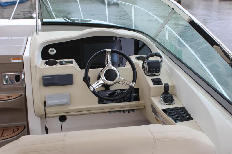 Slide: The Image of Cockpit of 2018 Regal 33 Express boat with steering wheel and control panel. - 11