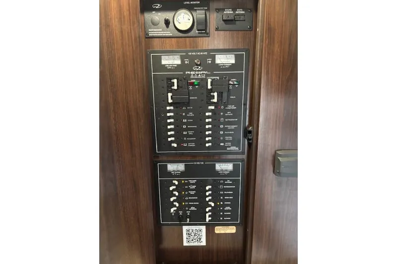 Slide: The Image of Electrical panel of a 2018 Regal 33 Express boat with control switches. - 21